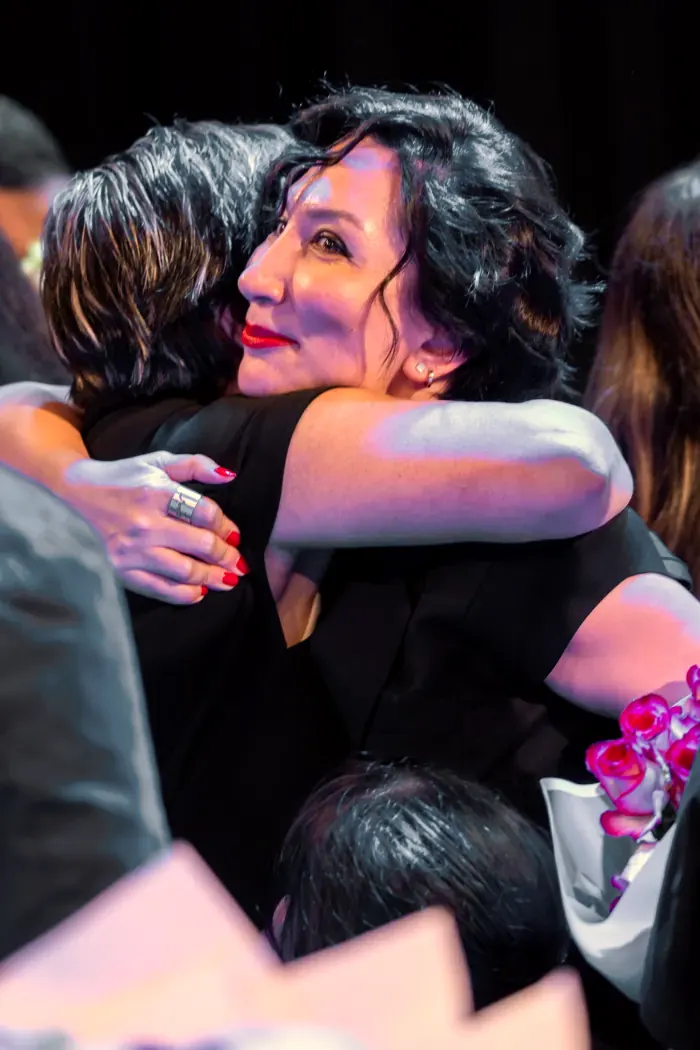 A teacher embracing a student after the concert