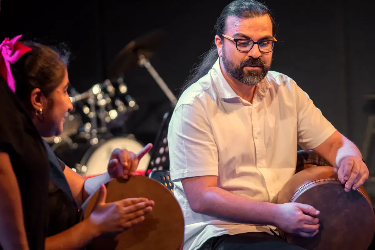 A daf teacher and a young student playing together
