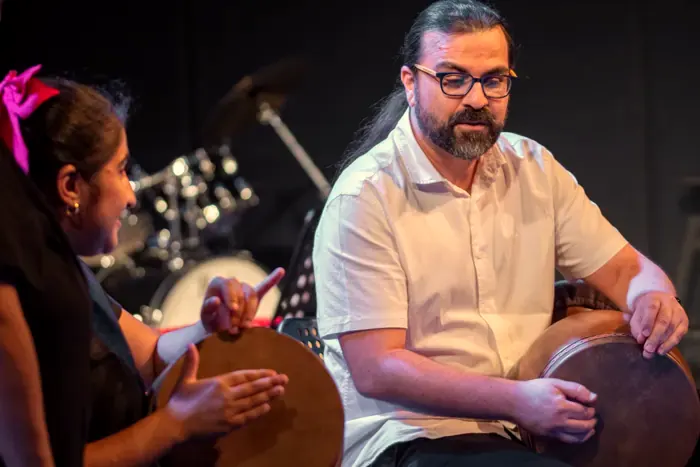 A daf teacher and a young student playing together