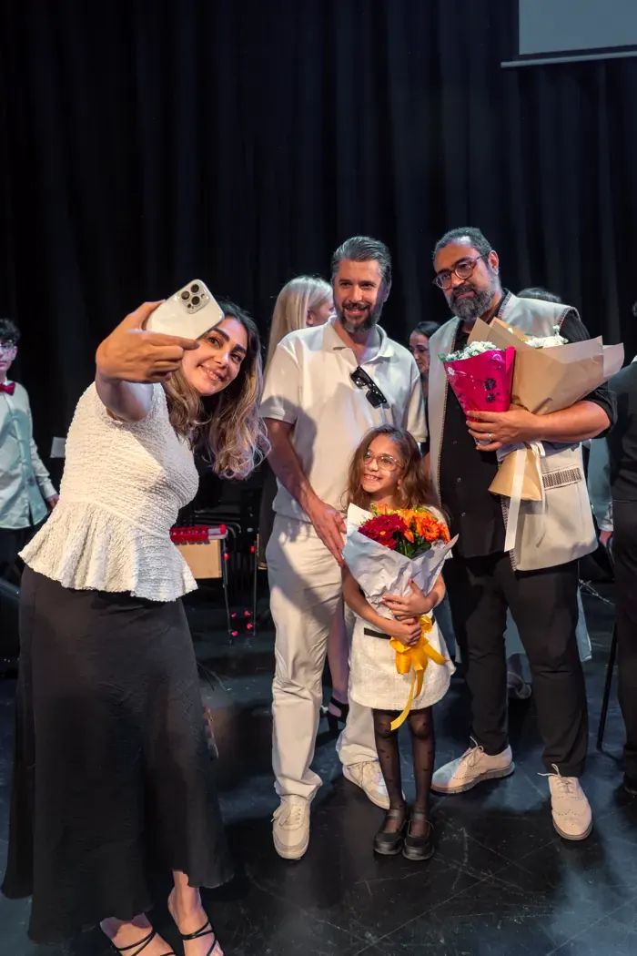 A young violinist with flowers after her first performance