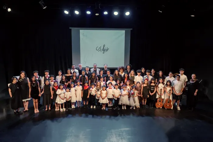 Students and teachers on stage after the concert